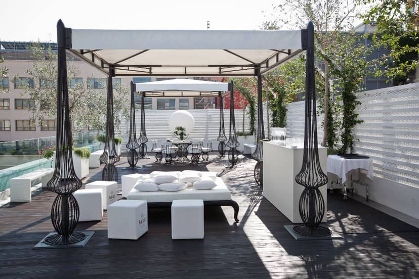 Upscale rooftop reception venue with chic lounge seating for corporate networking events.