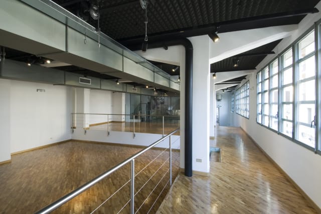 Industrial-chic Magna Pars event space with split-level layout for modern corporate events.