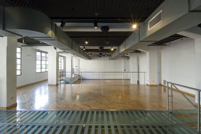 Industrial-chic event space with hardwood floors for gallery openings and pop-up activations.