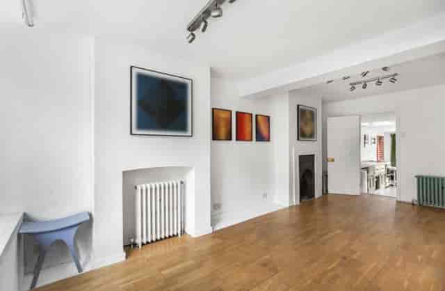 Minimalist breakout space with wood flooring for gallery pop-up or creative brainstorming sessions.