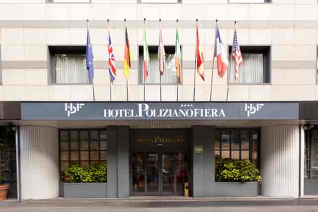 Hotel Poliziano CityLife: Four-star venue with prominent flags for corporate events and conferences.