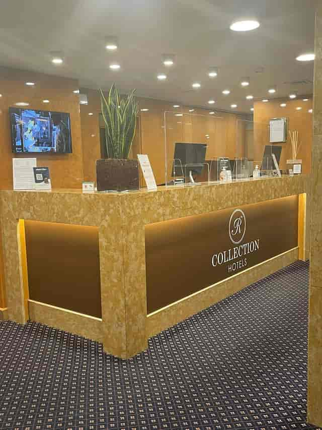Hotel registration desk with digital signage for professional event check-in and delegate services.
