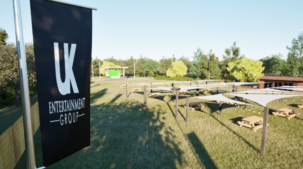 Corporate festival outdoor venue with stage and picnic seating for team building events.