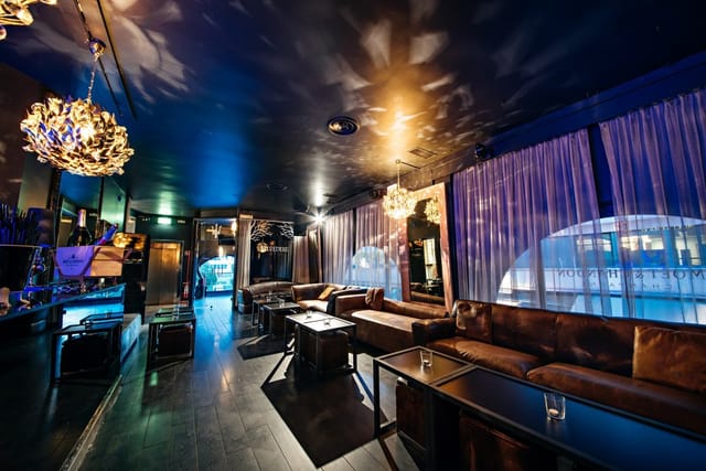 11Clubroom lounge with plush seating for VIP hospitality and executive networking events.