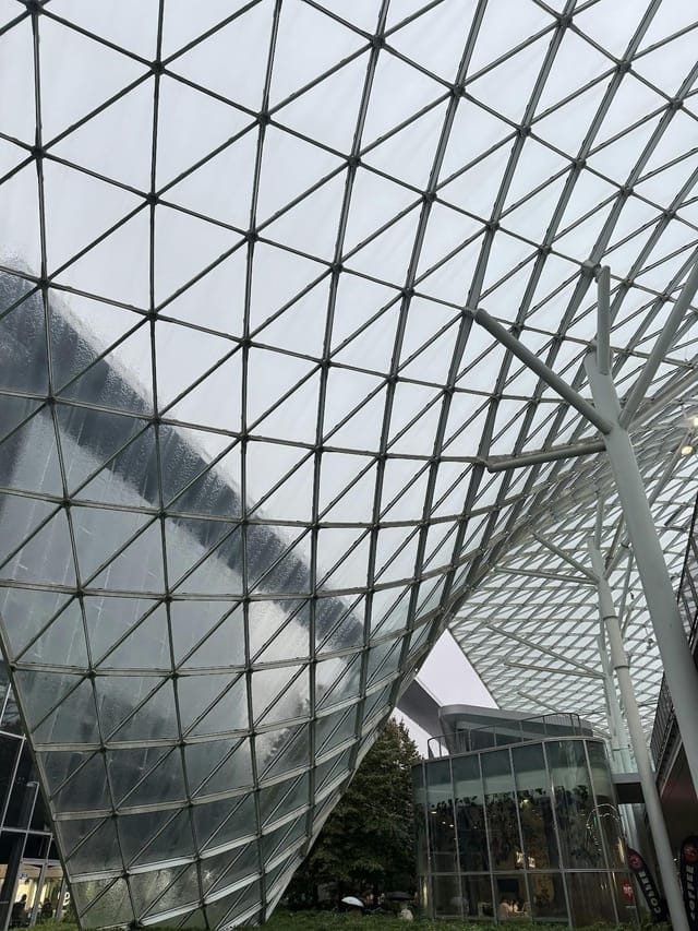 Modern Fiera Milano atrium with glass grid roof for upscale corporate events and exhibitions.