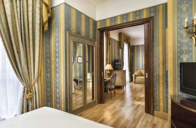 Luxury hotel suite with private workspace for executive travel and business meetings.
