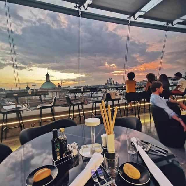 Panoramic sunset rooftop venue in Milan for upscale corporate networking and events.