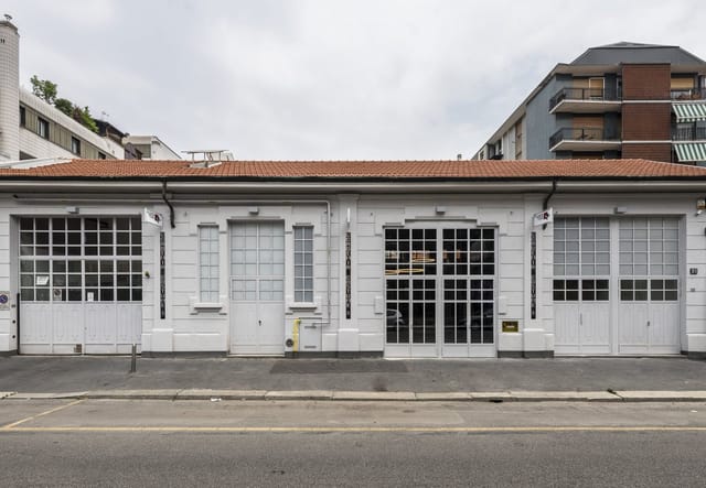 Industrial chic venue facade at Accademia Costume & Moda for pop-up events and gallery openings.