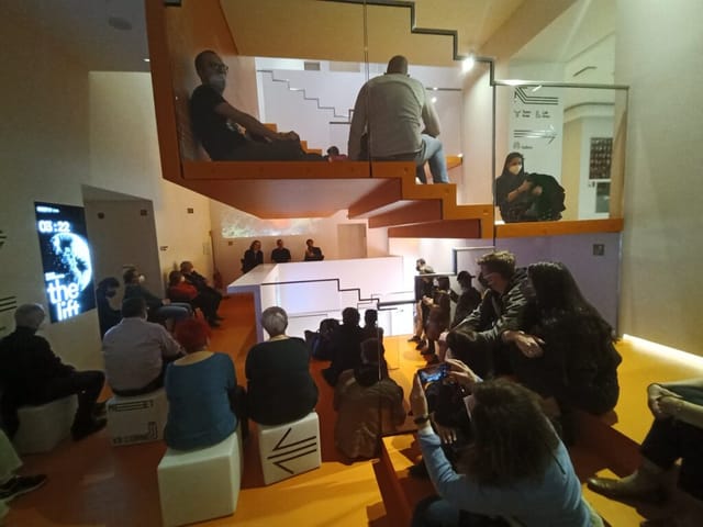 Immersive Room at MEET featuring tiered staircase seating for intimate presentations and events.