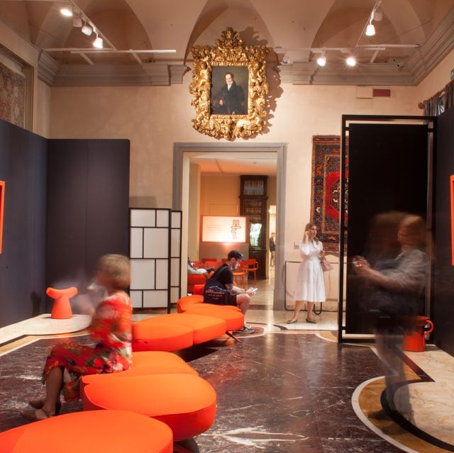 Orange modular lounge seating in Poldi Pezzoli Museum, an exhibition event venue interior.