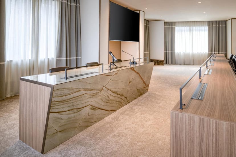 Contemporary boardroom with stone finishes for executive meetings and professional events.