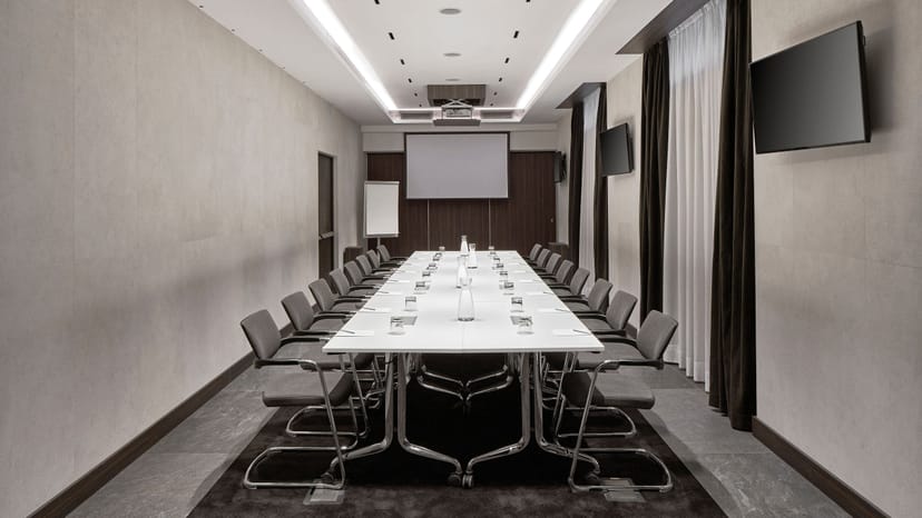 Boardroom at AC Hotel Milano: minimalist meeting space for corporate events and professional meetings.