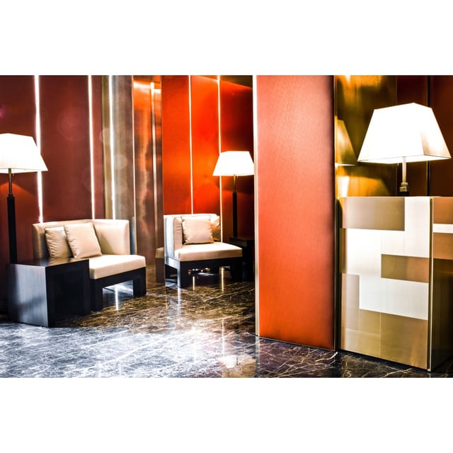 Upscale Allegroitalia Montenapoleone breakout lounge with warm-toned seating for VIP networking.