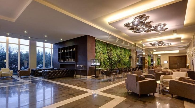 Contemporary hotel conference pre-function area with living wall for corporate event networking.