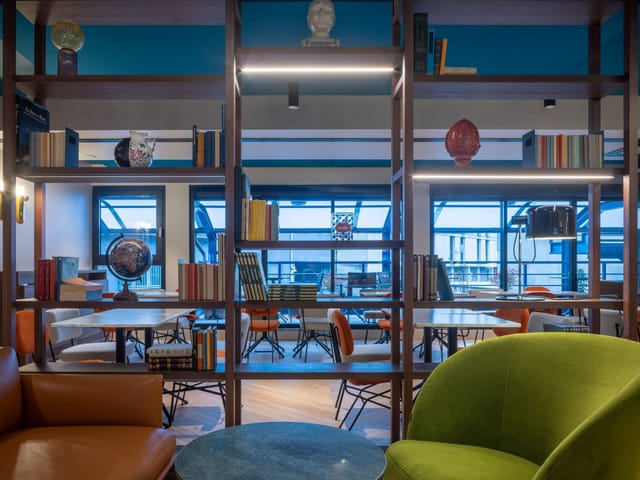 Modern Garibaldi meeting lounge, tiered seating, corporate event space for collaborative workshops.