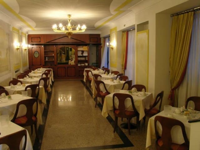 Formal banquet dining room at Hotel Marconi for intimate corporate events or wedding receptions.