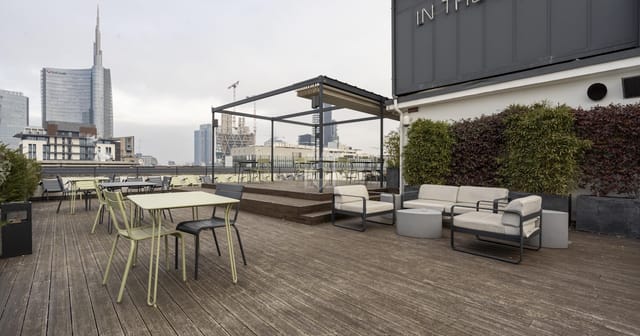 Rooftop meeting room with city skyline view for networking events and corporate presentations.