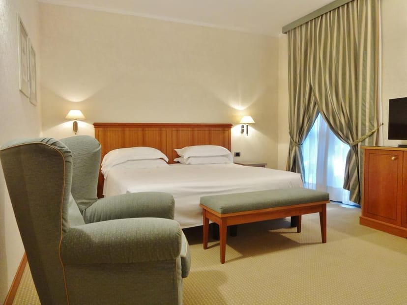 Hotel Excelsior Magenta conference room with functional seating for corporate meetings and events.