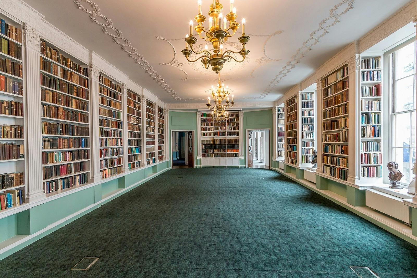 Elegant library with floor-to-ceiling bookshelves for literary events and gatherings.