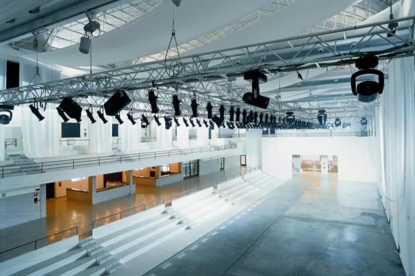 Foyer at La Pelota: industrial venue with tiered seating for fashion shows and product launches.