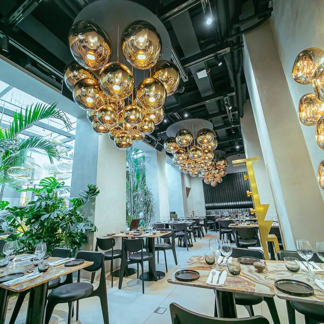 Modern restaurant dining space with sculptural lighting for corporate events and VIP receptions.