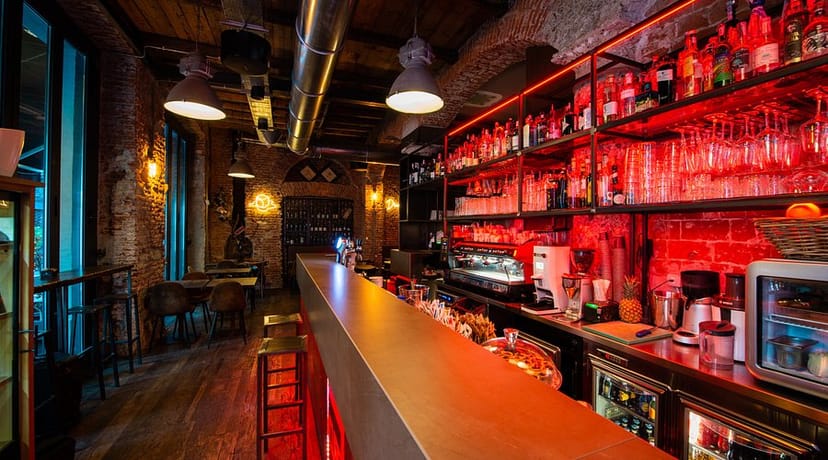 Industrial-chic reception venue with focal bar for networking events and corporate conferences.