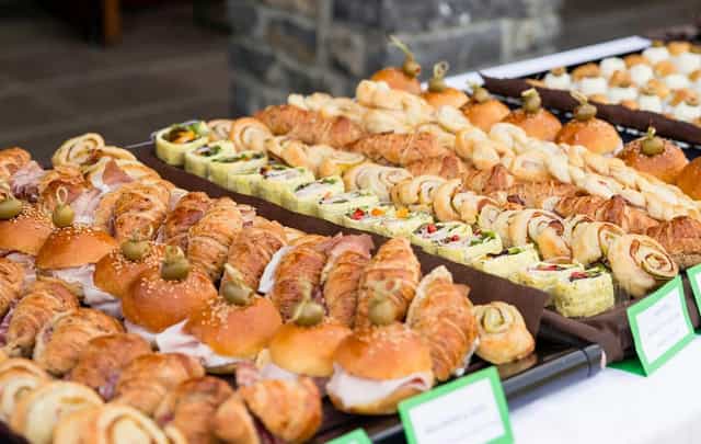 Catering spread of sliders and pastries at New York Lounge, Milan for corporate networking events.