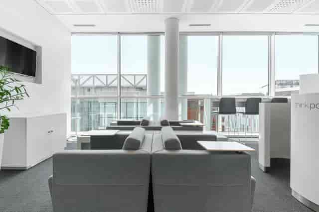 Modern business center breakout space with soft seating for corporate networking and events.