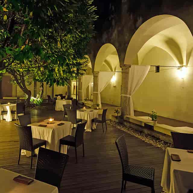 Chiostro delle Memorie wedding reception with ambient lighting and historic architecture.