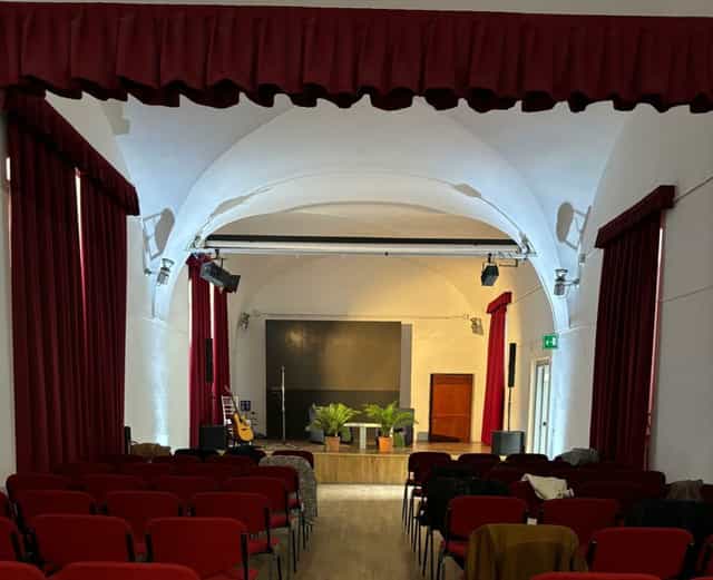 Historic auditorium with proscenium arch for boutique performances and corporate event venue.