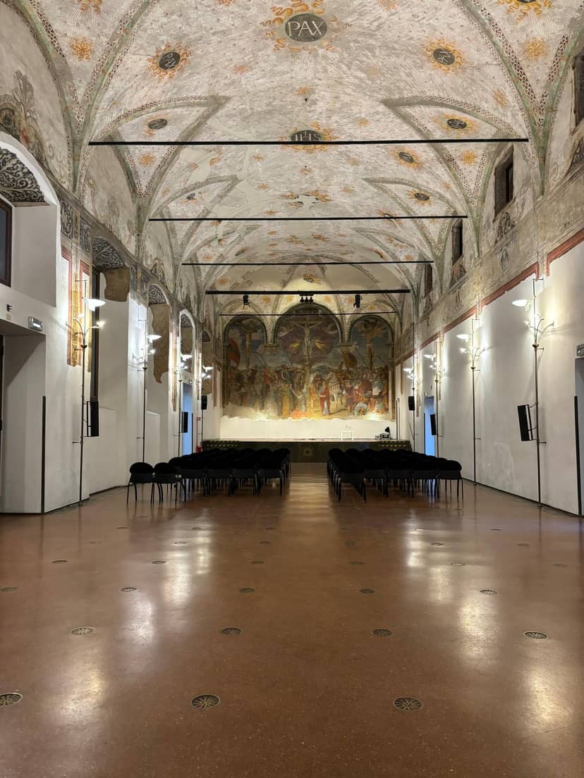 Historic auditorium venue with fresco backdrop for corporate events and professional conferences.