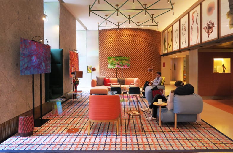 Modern breakout space at Room Mate Giulia, stylish meeting area for informal networking.