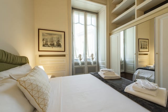 Luxury boutique hotel suite in Milan with modern bedding, perfect for VIP travel and group blocks.