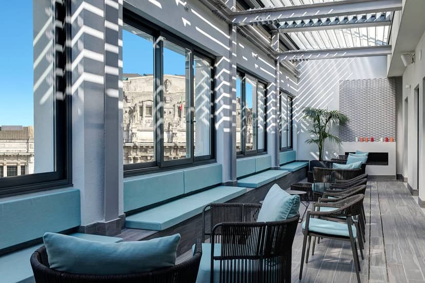 Rooftop terrace lounge at Hotel Ariston with vibrant lighting for VIP events and networking.