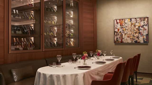 Upscale private dining room with wine cellar for VIP dinners and executive meetings.