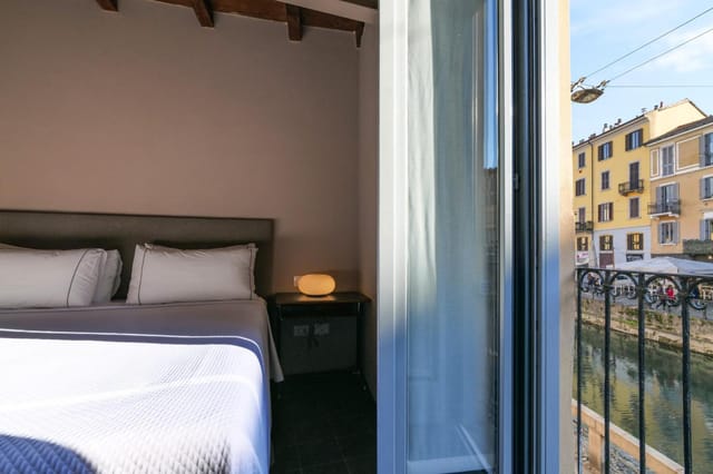 Modern hotel suite with canal-side balcony for luxury incentive travel and corporate events.