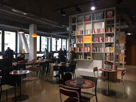 Open Milano bookstore cafe for collaborative coworking and networking events.
