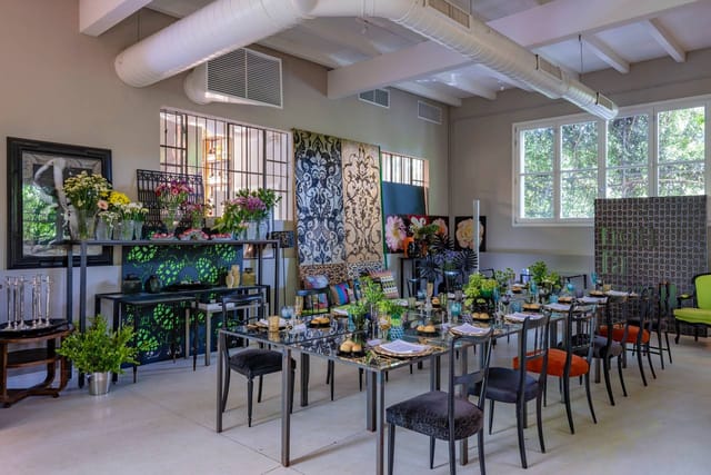 Industrial-chic dinner event space at Garden House Milano with elegant floral styling.