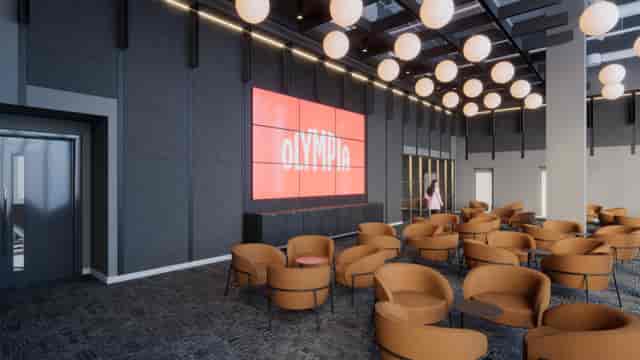 Modern lounge at Olympia International Convention Centre for networking and breakout sessions.