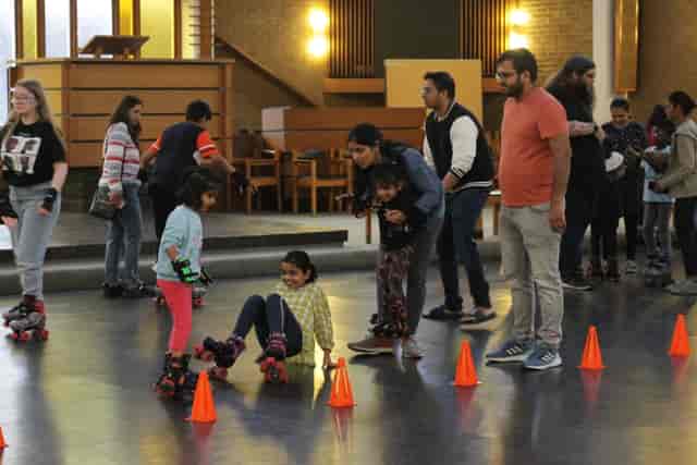 Pyramid Hall roller skating event with families and children, promoting fun and community.