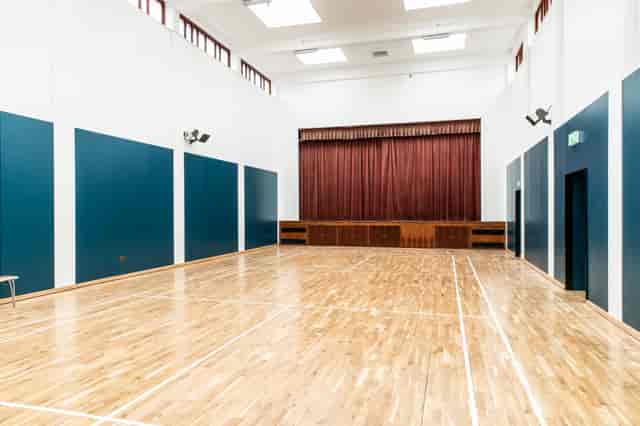 Spacious Sports Hall at The Pyramid, ideal for workshops and events with wooden flooring.