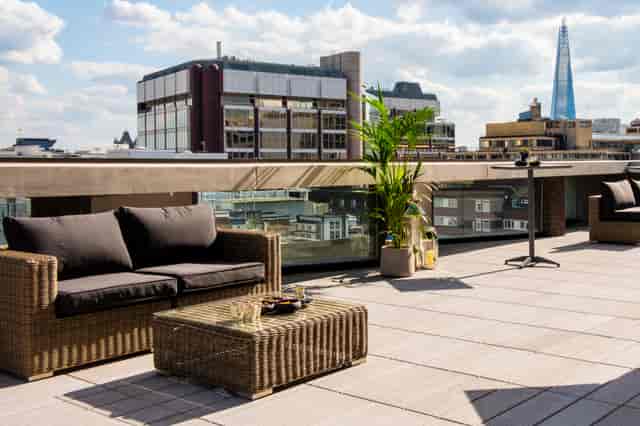 Stylish rooftop event space with city skyline for summer parties and cocktail receptions.