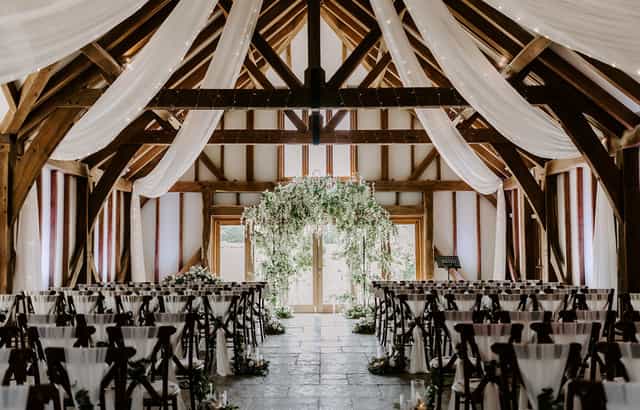 Elegant wedding ceremony at Brookfield Barn with floral arch and rustic charm.