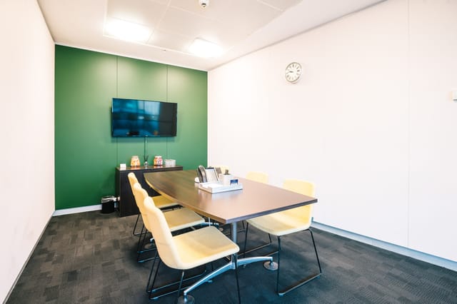 Compact Landmark breakout room with wall-mounted display for team meetings and virtual collaboration.