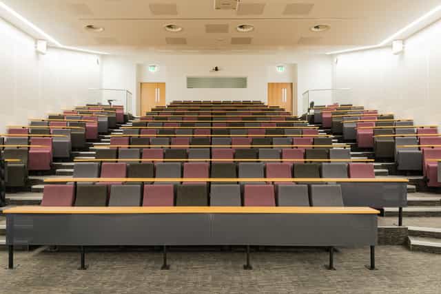 Tiered Lecture Theatre 2.008 with workstation desks for business workshops and plenary lectures.