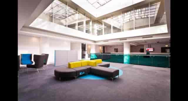 University of Salford MediaCity breakout space with modern seating for event networking.