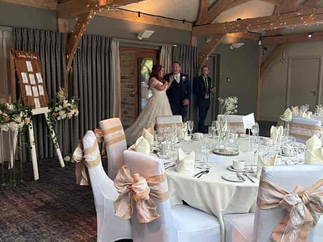 Rustic wedding reception with fairy lights and timber beams at Vintage Events venue.