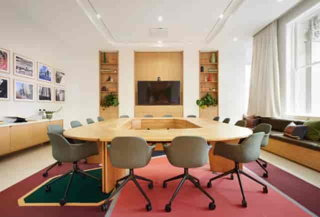 Modern boardroom in Grosvenor Building with hollow-square table for professional meetings.