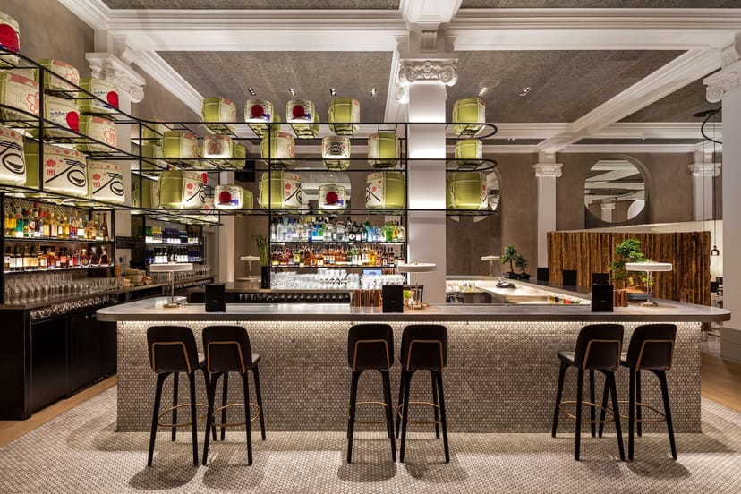 Modern bar with sake barrel display, ideal for upscale cocktail receptions and networking events.