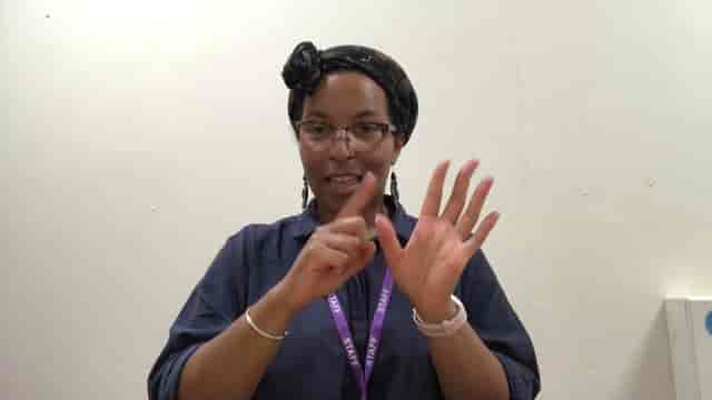 Staff member using sign language at Riley's Bar Manchester, inclusive event accessibility.